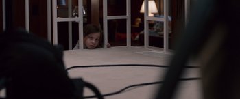 Movie still from “Room” (2015), directed by Lenny Abrahamson – A little girl is looking through a window; Medium shot, High angle