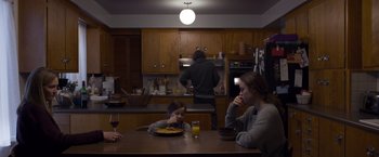 Movie still from “Room” (2015), directed by Lenny Abrahamson – A family is sitting at a kitchen table eating food; Wide shot, Over the shoulder angle