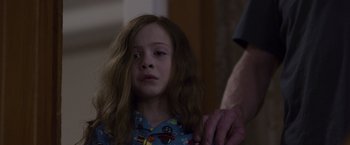 Movie still from “Room” (2015), directed by Lenny Abrahamson – A little girl with long red hair is looking at the camera; Close Up shot, Over the shoulder angle