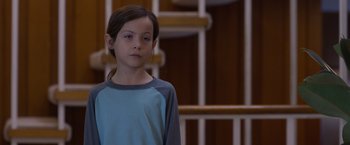 Movie still from “Room” (2015), directed by Lenny Abrahamson – A young girl standing in front of a staircase; Close Up shot, Over the shoulder angle