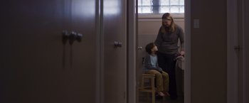Movie still from “Room” (2015), directed by Lenny Abrahamson – A woman and a child are standing in a room; Medium shot, Over the shoulder angle