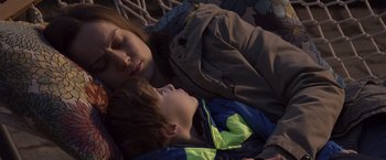 Movie still from “Room” (2015), directed by Lenny Abrahamson – A woman and a boy laying in a bed; Medium shot, High angle