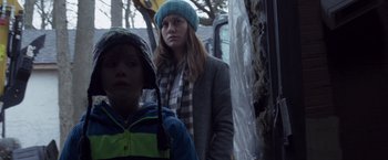 Movie still from “Room” (2015), directed by Lenny Abrahamson – A woman and a boy are standing on a bus; Medium shot, Over the shoulder angle