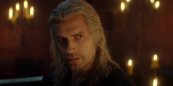 Movie still from “The Witcher” (2019), created by Lauren Schmidt Hissrich – A person with long blonde hair; Close Up shot, Over the shoulder angle