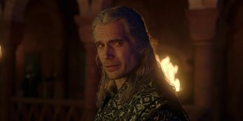Movie still from “The Witcher” (2019), created by Lauren Schmidt Hissrich – A person with long blonde hair; Close Up shot, Over the shoulder angle