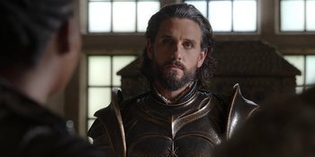 Movie still from “The Witcher” (2019), created by Lauren Schmidt Hissrich – A person wearing a suit of armor; Close Up shot, Over the shoulder angle
