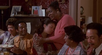 Movie still from “The Wiz” (1978), directed by Sidney Lumet – Two women and two men are gathered around a table; Medium shot, High angle
