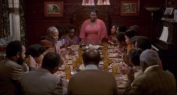 Movie still from “The Wiz” (1978), directed by Sidney Lumet – A group of people sitting around a dinner table; Wide shot, High angle
