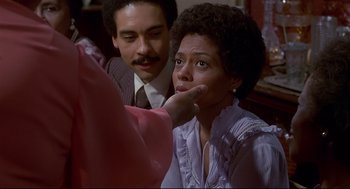 Movie still from “The Wiz” (1978), directed by Sidney Lumet – A woman sitting next to a man in a room; Close Up shot, Over the shoulder angle