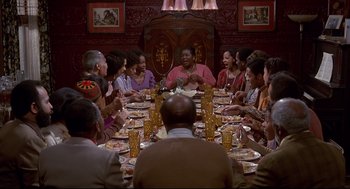 Movie still from “The Wiz” (1978), directed by Sidney Lumet – A group of people sitting around a table eating food; Wide shot, High angle