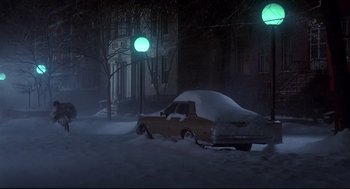 Movie still from “The Wiz” (1978), directed by Sidney Lumet – A car covered in snow on the side of the road; Extreme Wide shot, High angle