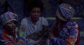 Movie still from “The Wiz” (1978), directed by Sidney Lumet – A woman sitting next to another woman holding a cat; Close Up shot, High angle