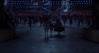 Movie still from “The Wiz” (1978), directed by Sidney Lumet – A group of people walking in the street at night; Extreme Wide shot, High angle