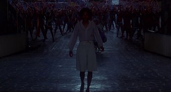 Movie still from “The Wiz” (1978), directed by Sidney Lumet – A woman walking in a crowd of people at night; Wide shot, High angle