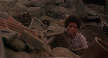 Movie still from “The Wiz” (1978), directed by Sidney Lumet – A woman is laying in a pile of rubble; Medium shot, High angle