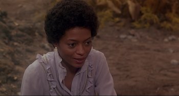 Movie still from “The Wiz” (1978), directed by Sidney Lumet – A woman sitting on the ground in front of rocks; Close Up shot, High angle