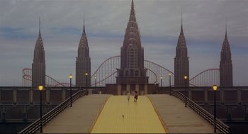 Movie still from “The Wiz” (1978), directed by Sidney Lumet – Two people are walking on a boardwalk near a bridge; Extreme Wide shot, High angle