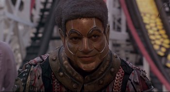 Movie still from “The Wiz” (1978), directed by Sidney Lumet – A man with a face mask and a hat; Close Up shot, Low angle