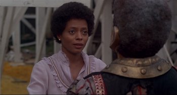 Movie still from “The Wiz” (1978), directed by Sidney Lumet – A woman in a pink shirt is talking to a man in a black suit; Close Up shot, Over the shoulder angle