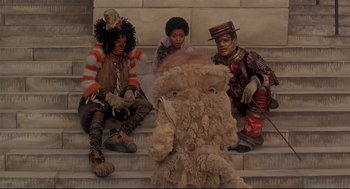 Movie still from “The Wiz” (1978), directed by Sidney Lumet – A group of people sitting next to each other on some steps; Wide shot, Low angle
