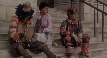 Movie still from “The Wiz” (1978), directed by Sidney Lumet – A group of people sitting on some steps; Wide shot, Low angle