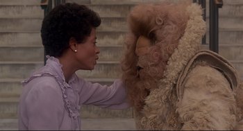 Movie still from “The Wiz” (1978), directed by Sidney Lumet – A woman touching the face of a stuffed animal; Medium shot, Over the shoulder angle