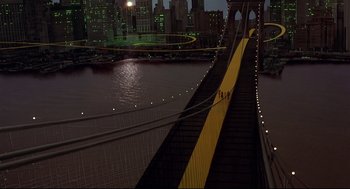 Movie still from “The Wiz” (1978), directed by Sidney Lumet – A view of a bridge with people walking on it at night; Extreme Wide shot, High angle