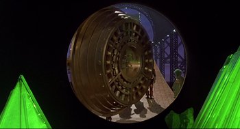 Movie still from “The Wiz” (1978), directed by Sidney Lumet – A view of a large metal object in a building; Wide shot, High angle