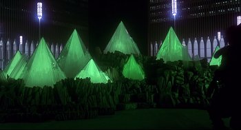Movie still from “The Wiz” (1978), directed by Sidney Lumet – A group of green lights are lit up in the shape of pyramids; Extreme Wide shot, Low angle