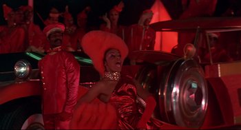 Movie still from “The Wiz” (1978), directed by Sidney Lumet – A woman in a red dress and a red hat; Medium shot, Low angle