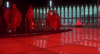 Movie still from “The Wiz” (1978), directed by Sidney Lumet – A group of people sitting on a chair in a room; Extreme Wide shot, Low angle