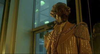 Movie still from “The Wiz” (1978), directed by Sidney Lumet – A statue of a black man wearing a gold dress; Medium shot, Low angle