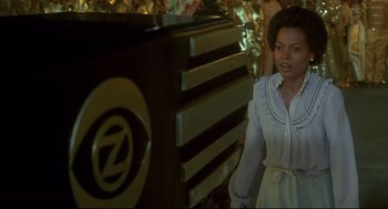 Movie still from “The Wiz” (1978), directed by Sidney Lumet – A woman standing in front of an oven in a kitchen; Medium shot, Over the shoulder angle