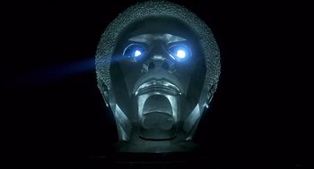 Movie still from “The Wiz” (1978), directed by Sidney Lumet – A metal sculpture of a man's face lit up with a blue light; Close Up shot, Low angle