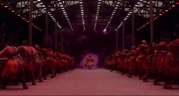 Movie still from “The Wiz” (1978), directed by Sidney Lumet – A group of people are sitting in the middle of a stage; Extreme Wide shot, Low angle