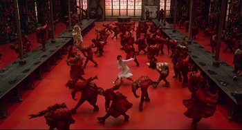 Movie still from “The Wiz” (1978), directed by Sidney Lumet – A group of people in a room with red floors; Extreme Wide shot, High angle