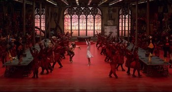 Movie still from “The Wiz” (1978), directed by Sidney Lumet – A group of people are dancing on a red floor; Extreme Wide shot, High angle
