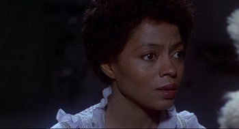 Movie still from “The Wiz” (1978), directed by Sidney Lumet – A person wearing a white shirt; Close Up shot, Over the shoulder angle