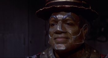 Movie still from “The Wiz” (1978), directed by Sidney Lumet – A person wearing a mask; Close Up shot, High angle