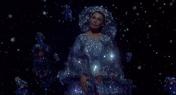 Movie still from “The Wiz” (1978), directed by Sidney Lumet – A woman dressed in a blue dress with a lot of sparkles around her; Medium shot, High angle