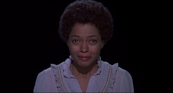 Movie still from “The Wiz” (1978), directed by Sidney Lumet – A black woman with short curly hair wearing a white shirt; Close Up shot, Low angle