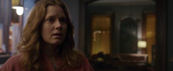 Movie still from “The Woman in the Window” (2021), directed by Joe Wright – A person with long hair; Close Up shot, Over the shoulder angle