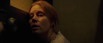 Movie still from “The Woman in the Window” (2021), directed by Joe Wright – A person with red hair; Close Up shot, Low angle