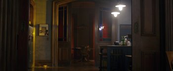 Movie still from “The Woman in the Window” (2021), directed by Joe Wright – A room with a table and chairs in it; Wide shot, High angle