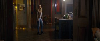 Movie still from “The Woman in the Window” (2021), directed by Joe Wright – A woman standing in front of a dining room table; Wide shot, Over the shoulder angle