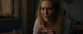 Movie still from “The Woman in the Window” (2021), directed by Joe Wright – A person holding a necklace; Close Up shot, Overhead angle