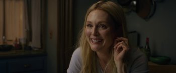 Movie still from “The Woman in the Window” (2021), directed by Joe Wright – A woman smiling while holding her hand up to her ear; Close Up shot, Over the shoulder angle