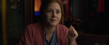 Movie still from “The Woman in the Window” (2021), directed by Joe Wright – A person sitting in a room; Close Up shot, Over the shoulder angle