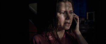 Movie still from “The Woman in the Window” (2021), directed by Joe Wright – A person with wet hair; Close Up shot, High angle