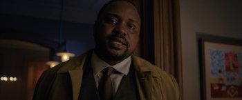 Movie still from “The Woman in the Window” (2021), directed by Joe Wright – A man in a brown jacket and a brown tie; Close Up shot, Over the shoulder angle